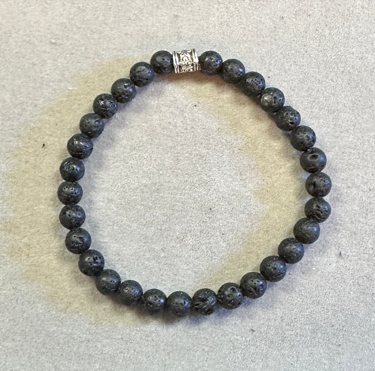 Beaded bracelet with a silver clasp on a light gray background