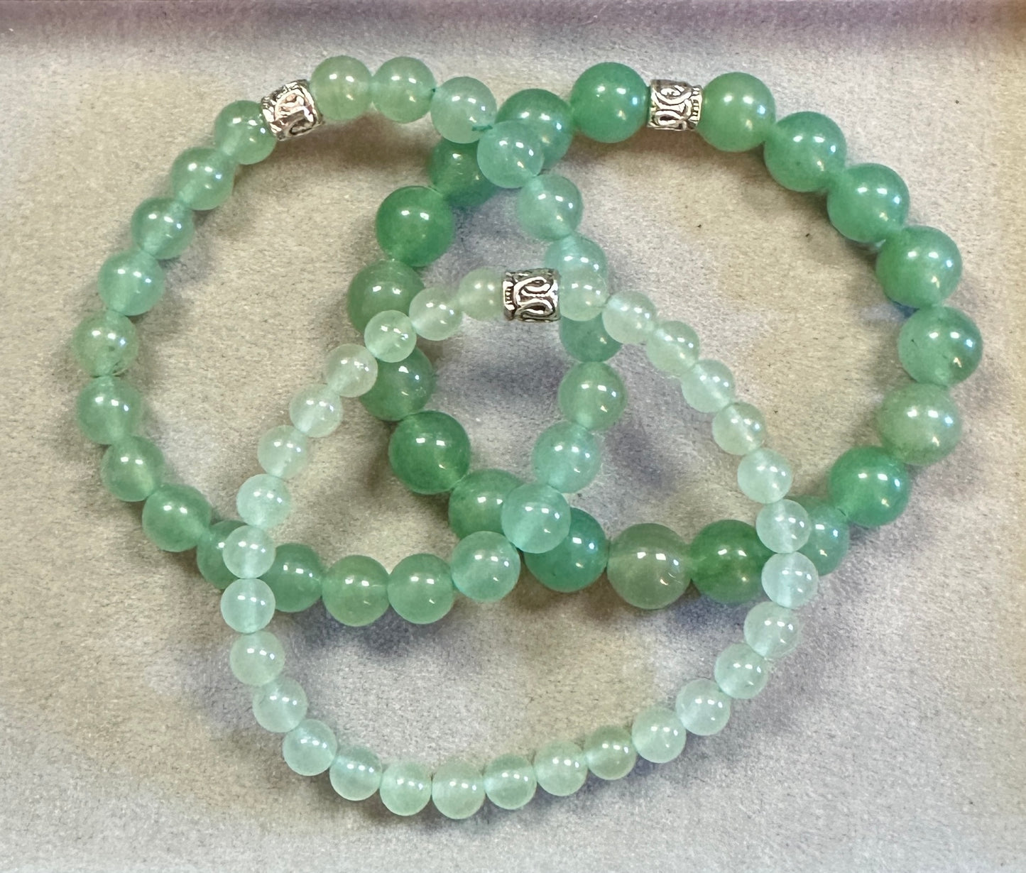 Green beaded necklace on a textured surface