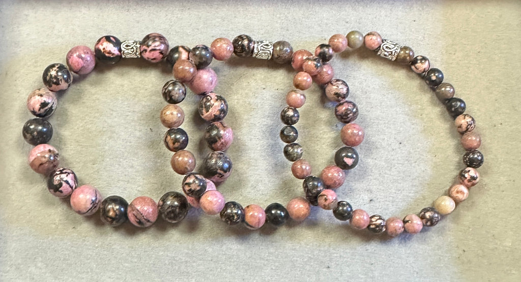 Three beaded bracelets on a textured surface