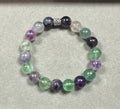 Multicolored beaded bracelet on a light gray background