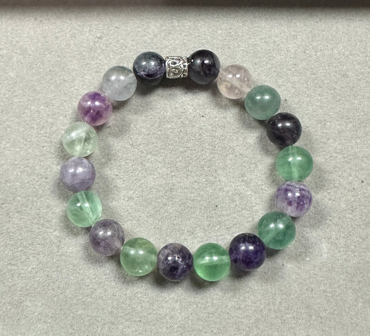 Multicolored beaded bracelet on a light gray background