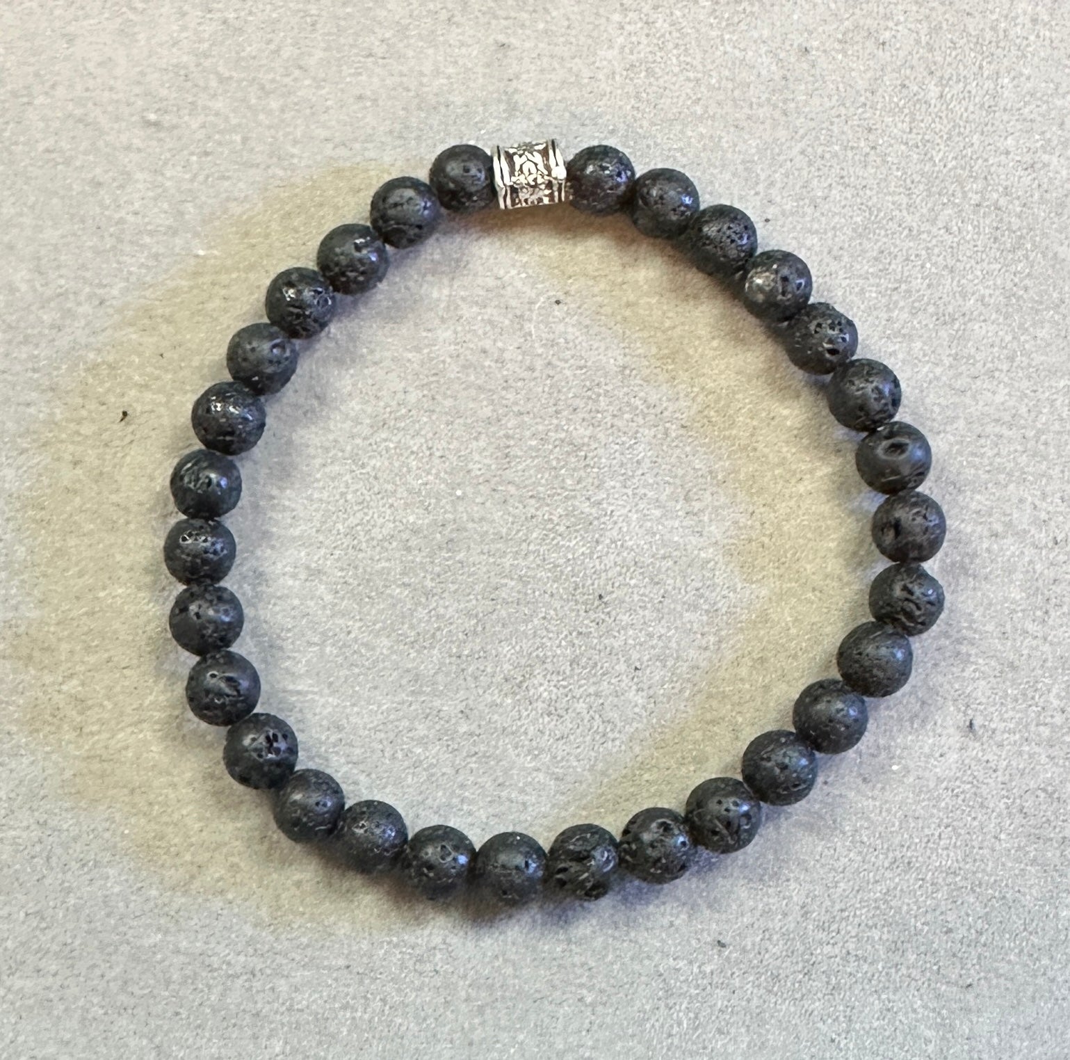 Beaded bracelet with a silver clasp on a light gray background