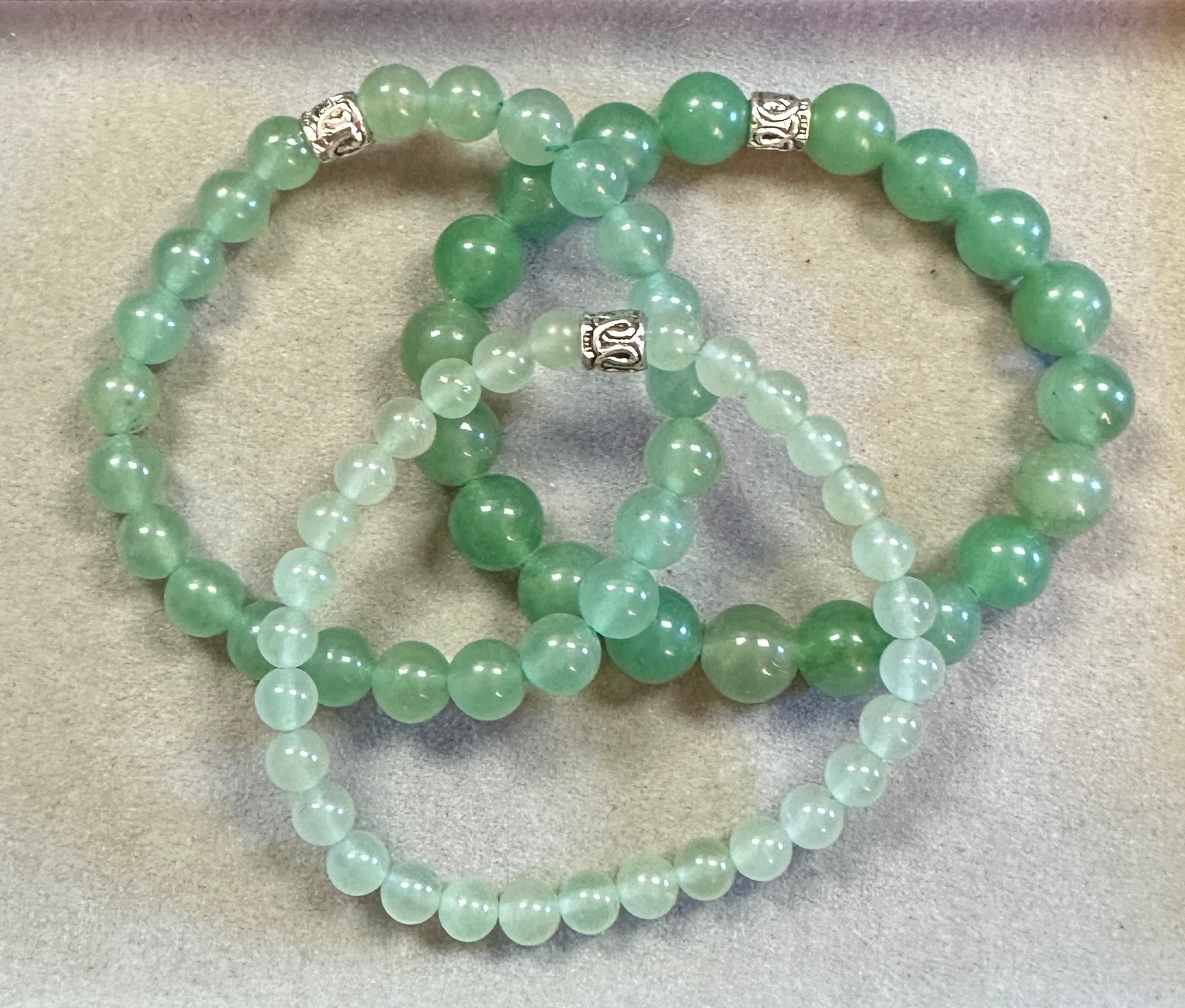 Green beaded necklace on a textured surface